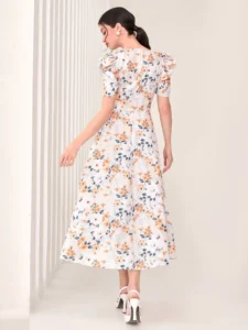  Image of a woman wearing a SHEIN Floral Print Puff Sleeve Dress, showcasing its vibrant floral design and fashionable puff sleeves, perfect for adding a touch of romance to any outfit.